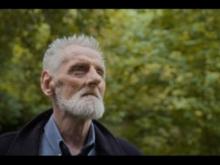 An old man in a forest.