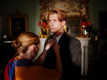Main actor is being dressed on set by a crew member. © Panenka en Ilias Van Bambost